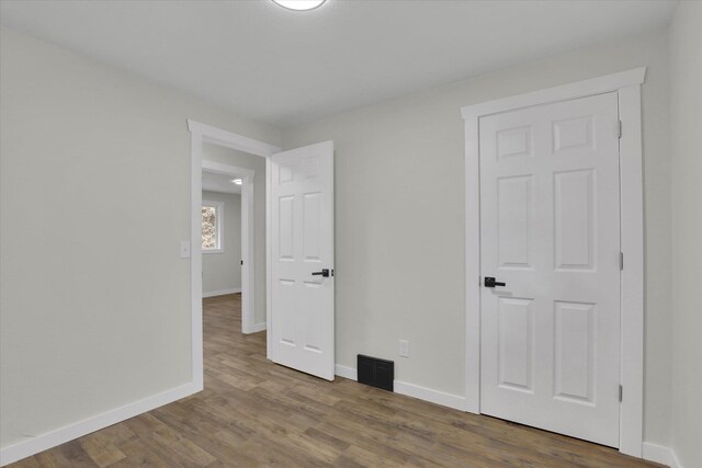 office space with dark hardwood / wood-style flooring, a large fireplace, and beamed ceiling