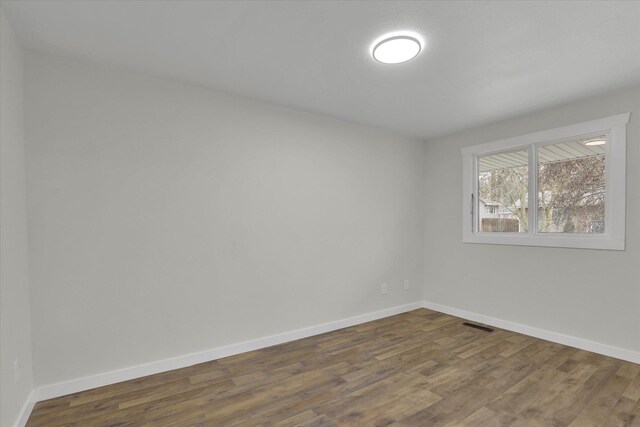 kitchen with dark hardwood / wood-style flooring and stainless steel range with electric cooktop