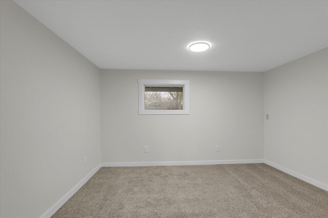 unfurnished room featuring dark colored carpet