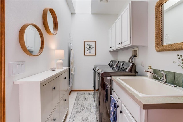 laundry room featuring cabinets, washer and dryer, and sink