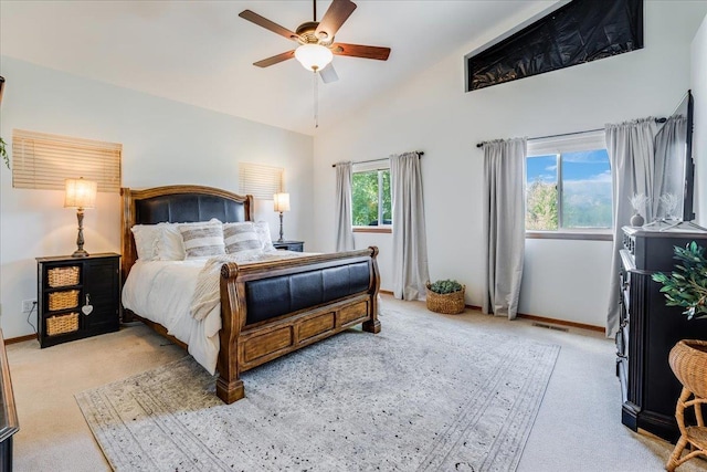 bedroom featuring ceiling fan, high vaulted ceiling, and light carpet