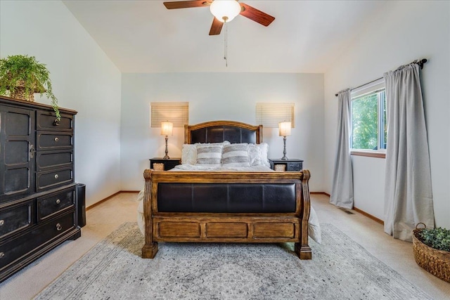 bedroom with ceiling fan and light carpet