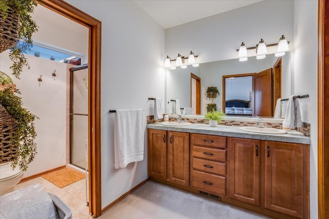 bathroom featuring vanity and a shower with door