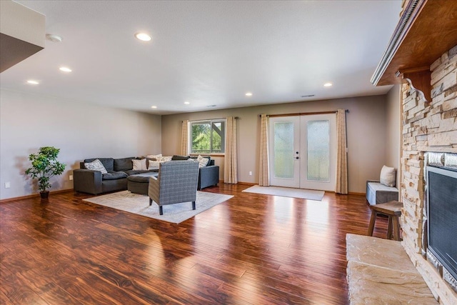 living room with hardwood / wood-style flooring, a fireplace, and french doors