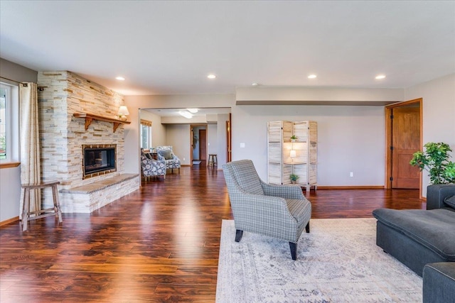 living room featuring wood-type flooring, a wealth of natural light, and a fireplace