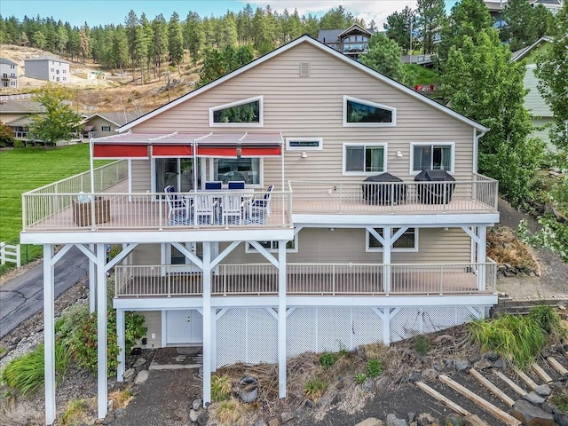 rear view of property featuring a balcony