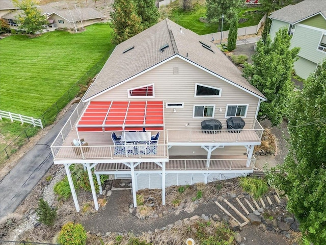 rear view of house featuring a yard and a deck