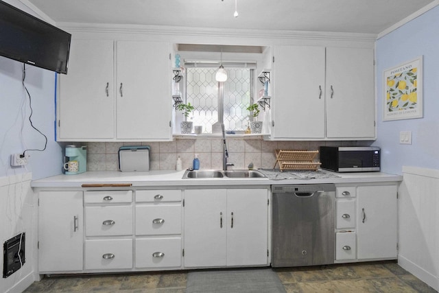 kitchen with tasteful backsplash, white cabinetry, sink, hanging light fixtures, and stainless steel appliances