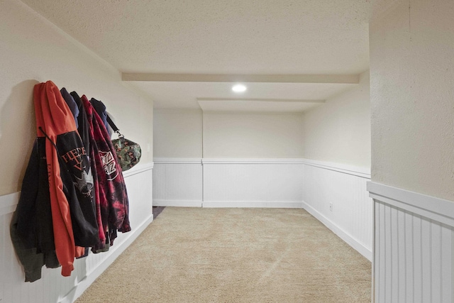 carpeted empty room with a textured ceiling