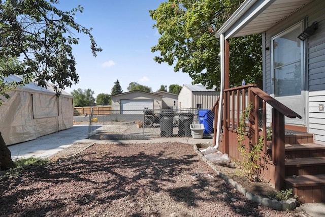 view of yard with a garage and an outbuilding