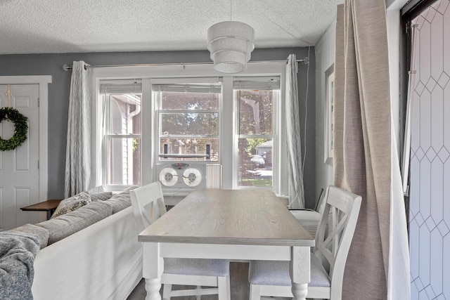 dining area featuring a textured ceiling