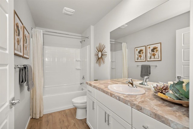 full bathroom with vanity, shower / tub combo, hardwood / wood-style flooring, and toilet