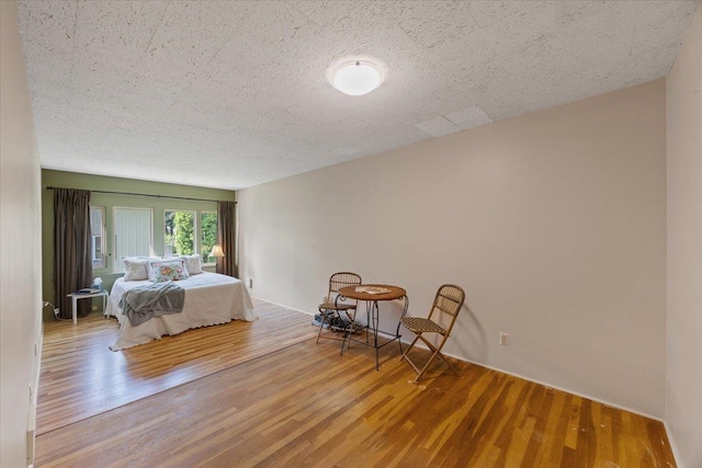 bedroom featuring wood-type flooring and a textured ceiling