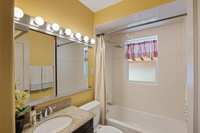 full bathroom with shower / bathtub combination with curtain, vanity, and toilet