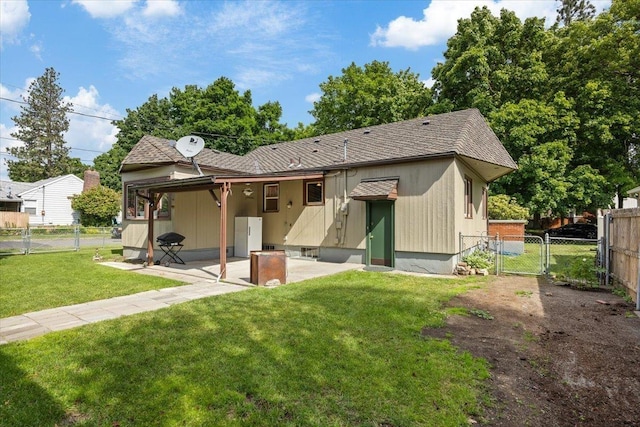 rear view of property featuring a patio and a lawn