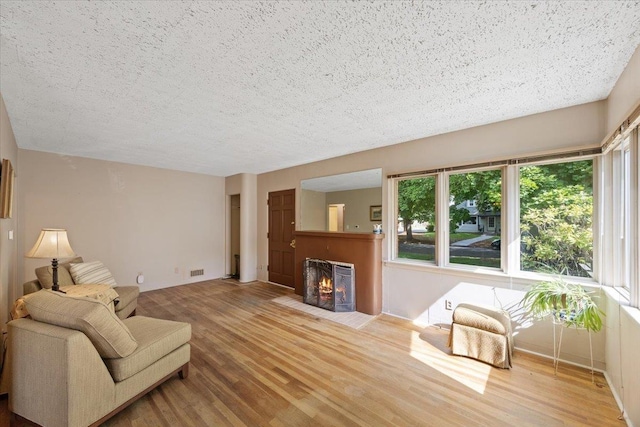 living room with hardwood / wood-style floors and a textured ceiling