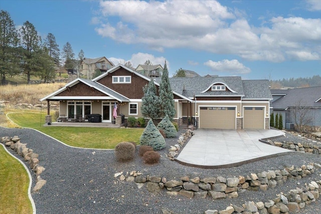 craftsman house featuring driveway, a front lawn, and an attached garage