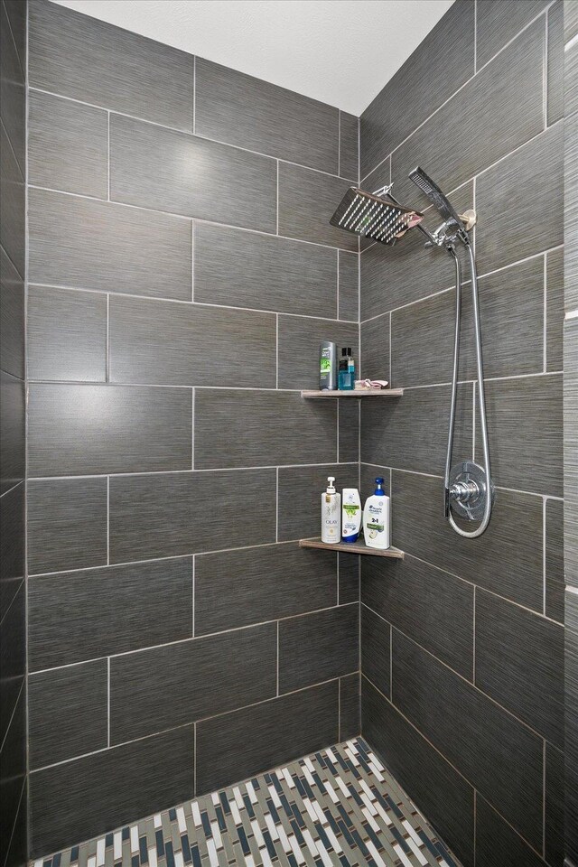 bathroom with a tile shower