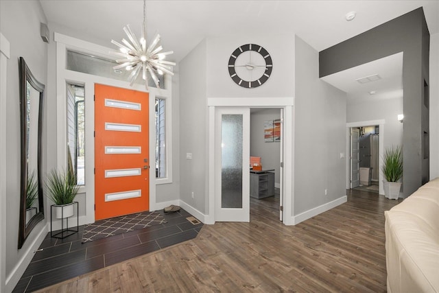 foyer featuring dark hardwood / wood-style flooring and a chandelier