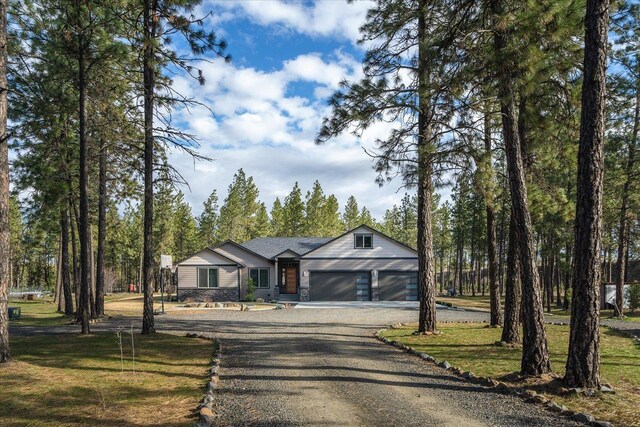 view of front of home featuring a garage and a front yard