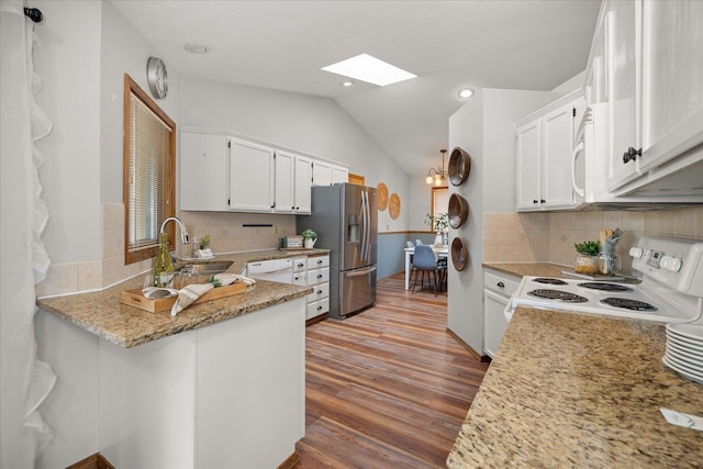 kitchen featuring white cabinetry, light stone counters, and white appliances