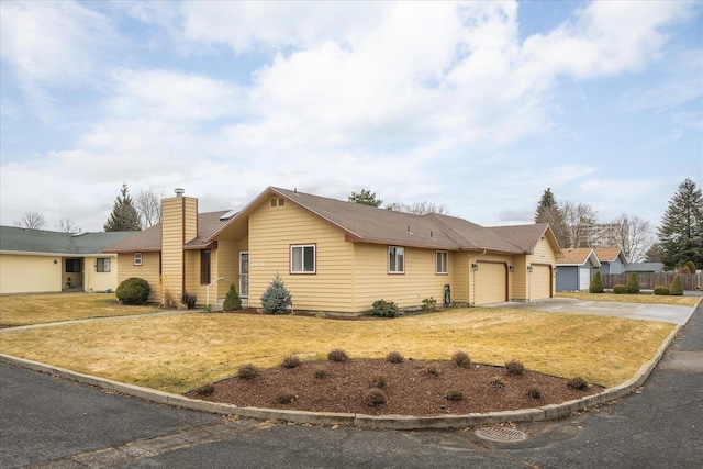 ranch-style house with a garage and a front yard