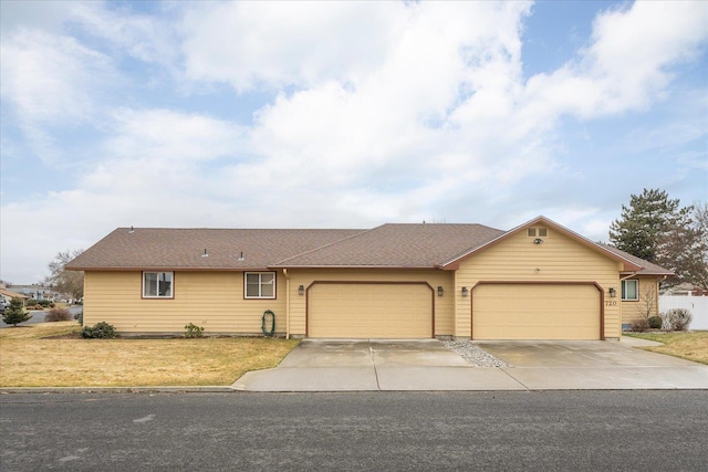 single story home featuring a garage and a front lawn