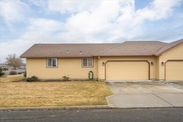 single story home featuring a garage and a front yard