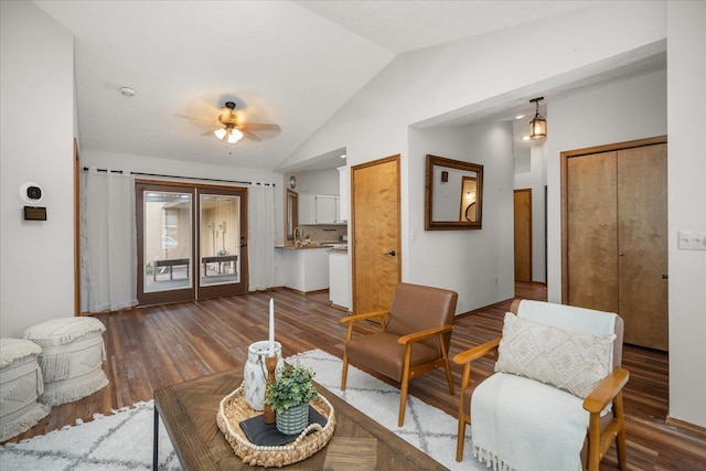 living room with ceiling fan, lofted ceiling, and dark hardwood / wood-style flooring