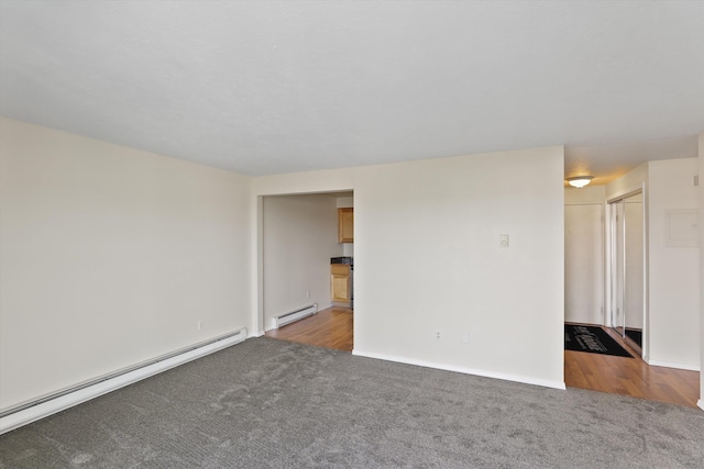 carpeted empty room with baseboard heating