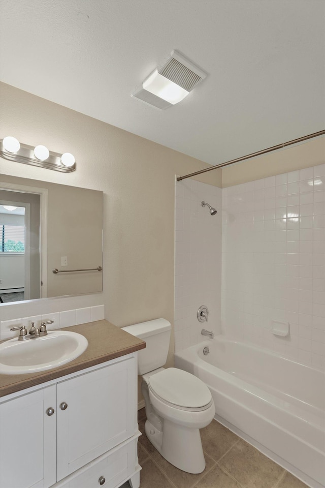 full bathroom featuring tiled shower / bath combo, vanity, tile patterned floors, and toilet