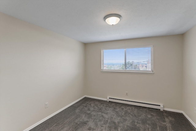 carpeted empty room with a baseboard radiator and a textured ceiling