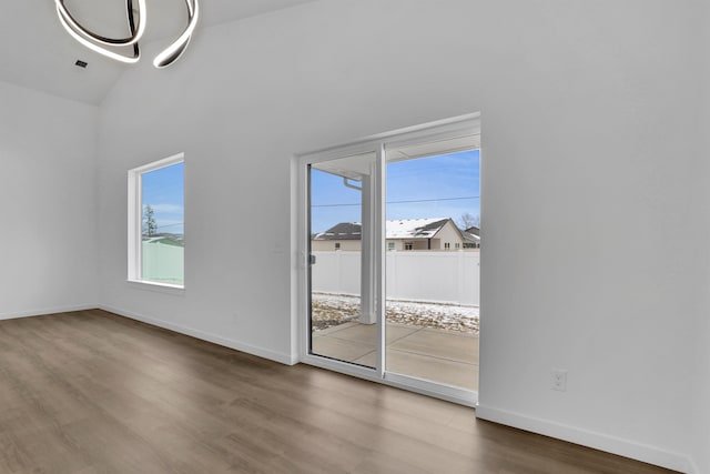 interior space featuring hardwood / wood-style flooring and lofted ceiling