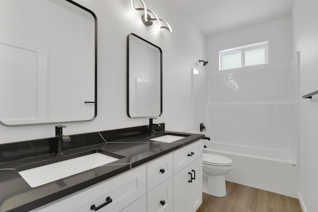 full bathroom with shower / bathtub combination, vanity, toilet, and hardwood / wood-style floors