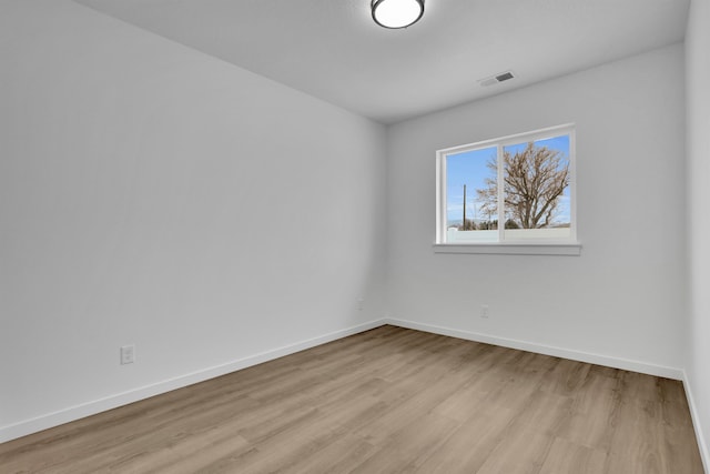 spare room featuring light hardwood / wood-style floors