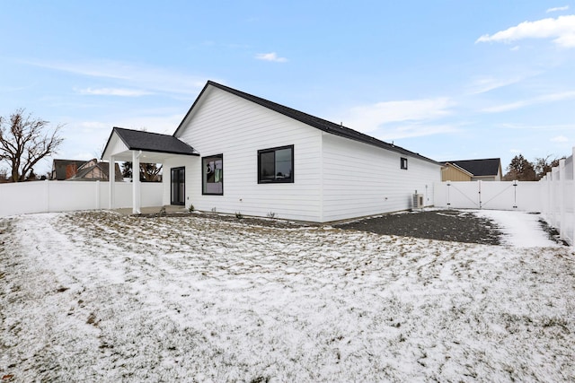 snow covered house with cooling unit