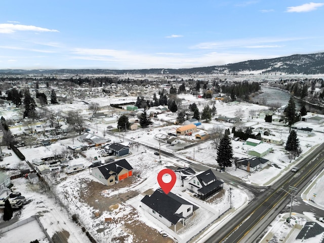 snowy aerial view with a mountain view