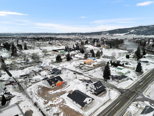 snowy aerial view with a mountain view