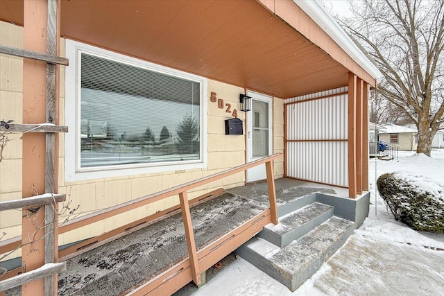 view of snow covered property entrance