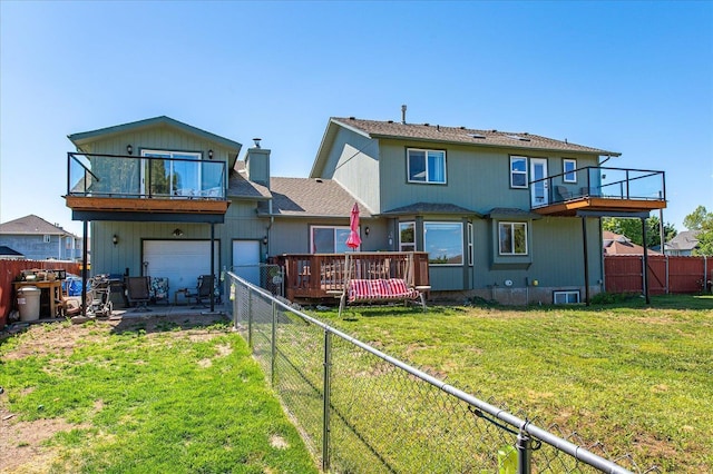 back of house with a wooden deck and a lawn