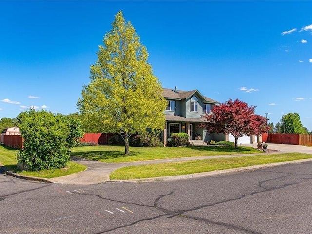 view of front of property featuring a garage and a front yard