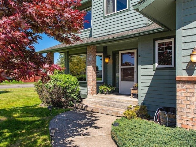 doorway to property featuring a lawn