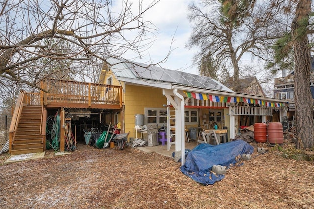 back of house with a wooden deck