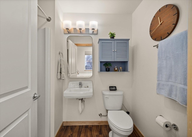 bathroom with sink, wood-type flooring, and toilet