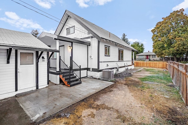 rear view of house featuring central AC unit