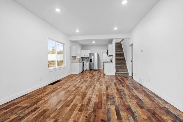 unfurnished living room with hardwood / wood-style flooring