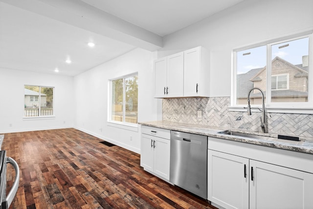 kitchen with sink, dishwasher, white cabinetry, light stone counters, and decorative backsplash