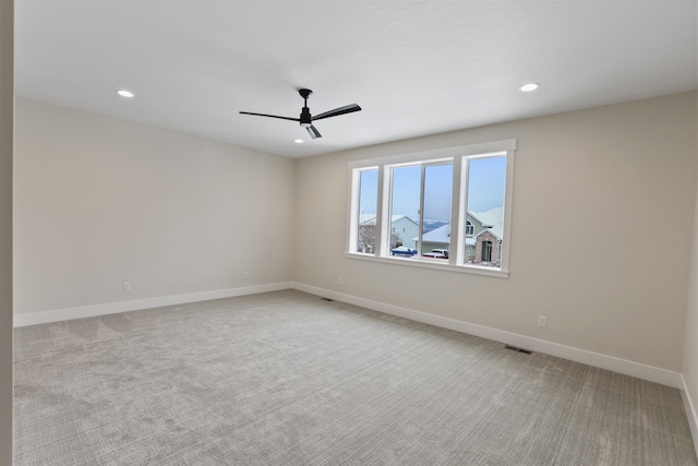 carpeted empty room featuring ceiling fan