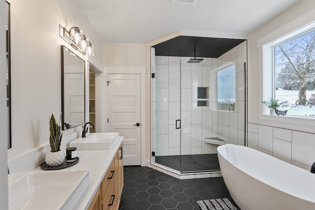 bathroom with tile patterned floors, vanity, plus walk in shower, and tile walls