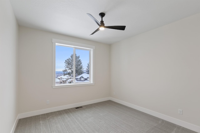 carpeted empty room featuring ceiling fan